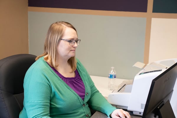 An employee working on her computer.