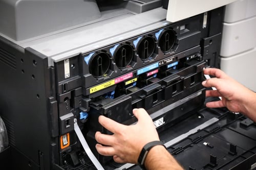 Man replacing toner cartridge