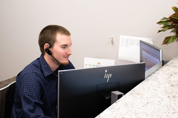 A young professional researching information at his workstation.