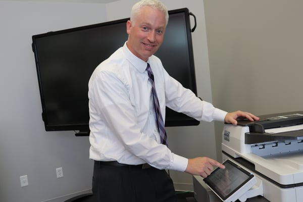 A man using his copier machine